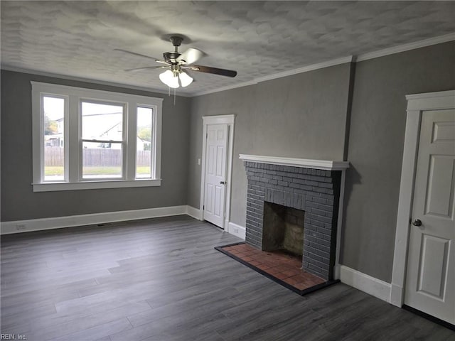 unfurnished living room with a fireplace, dark wood-type flooring, ceiling fan, and crown molding