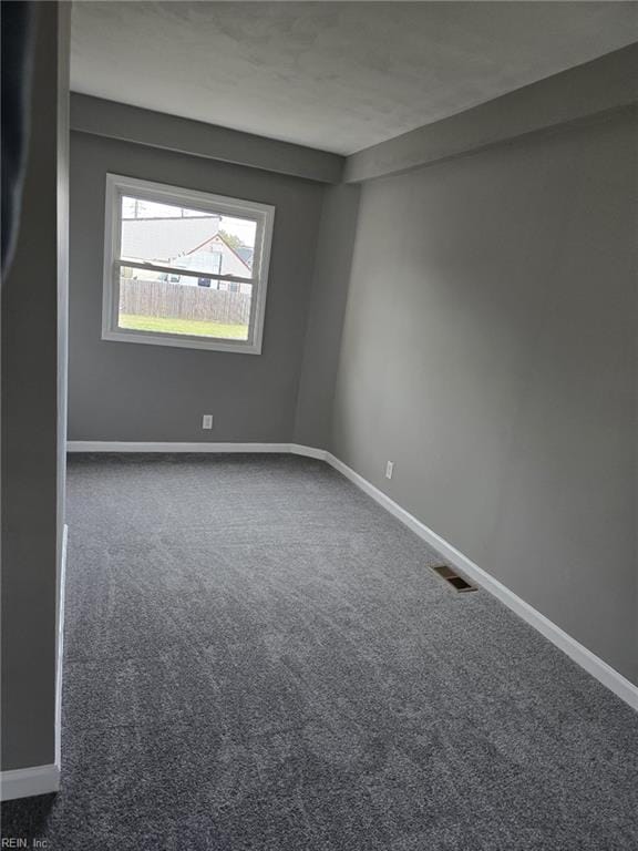 empty room featuring dark colored carpet