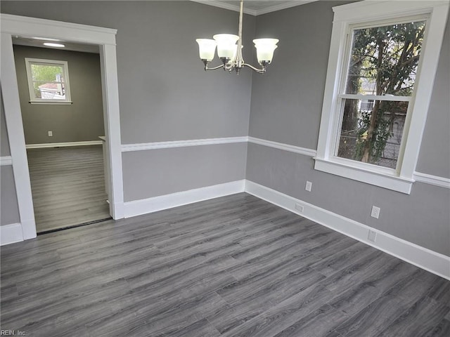 unfurnished dining area with dark wood-type flooring, a chandelier, and ornamental molding