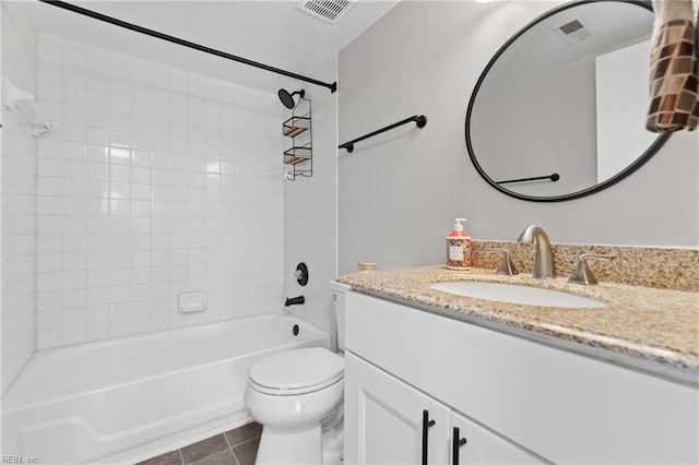 full bathroom featuring vanity, toilet, tile patterned floors, and tiled shower / bath combo