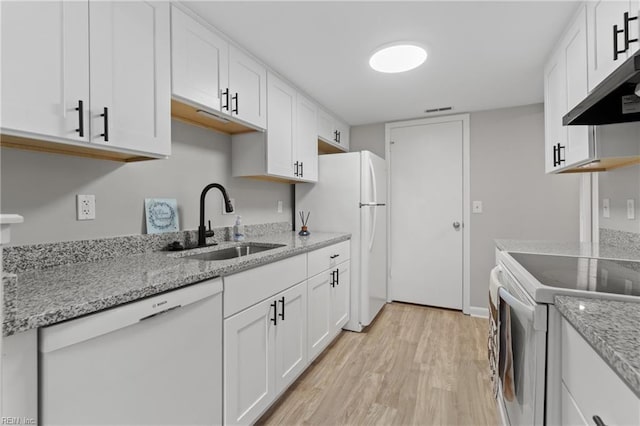 kitchen featuring sink, white appliances, white cabinets, and light wood-type flooring