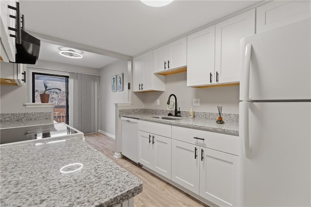 kitchen featuring sink, white appliances, white cabinets, and light stone counters