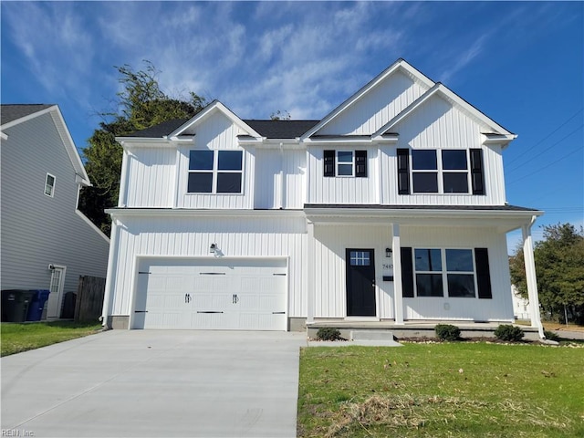 view of front of property featuring a porch, a garage, and a front lawn