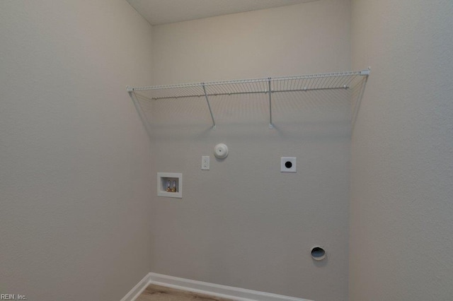 washroom featuring gas dryer hookup, washer hookup, hardwood / wood-style floors, and electric dryer hookup