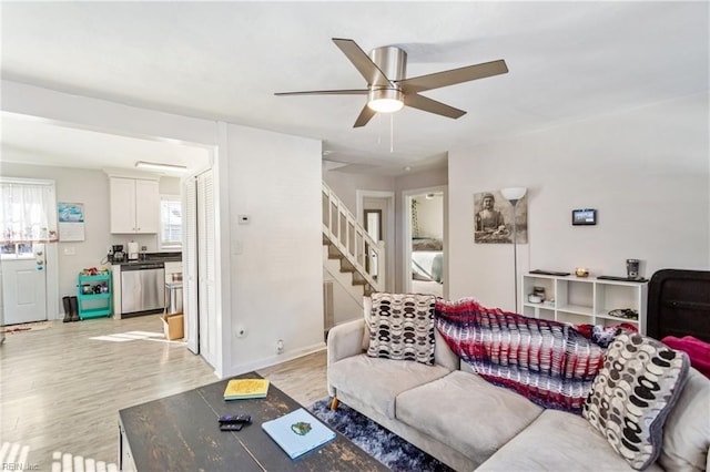 living room featuring light hardwood / wood-style flooring and ceiling fan