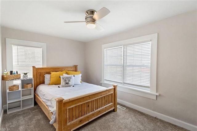 bedroom with ceiling fan, carpet floors, and multiple windows