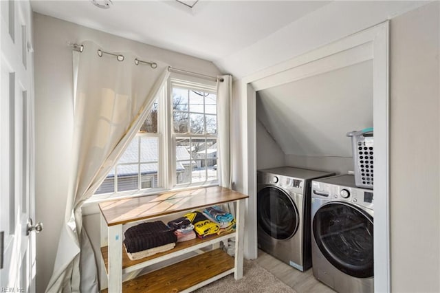 washroom with independent washer and dryer and light wood-type flooring