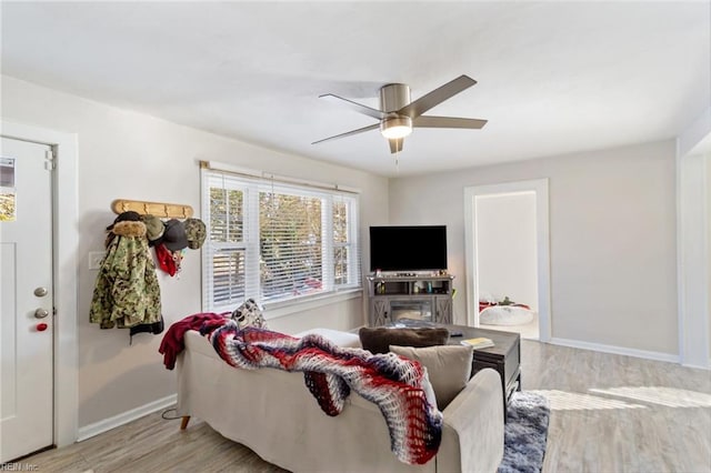 living room featuring ceiling fan and light hardwood / wood-style flooring