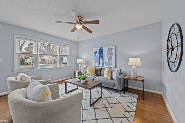 living room featuring light hardwood / wood-style floors and ceiling fan