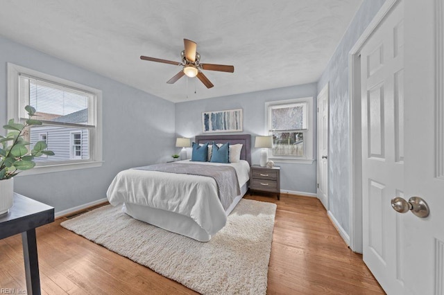 bedroom with light wood-type flooring and ceiling fan