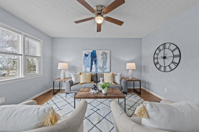 living room featuring ceiling fan and wood-type flooring