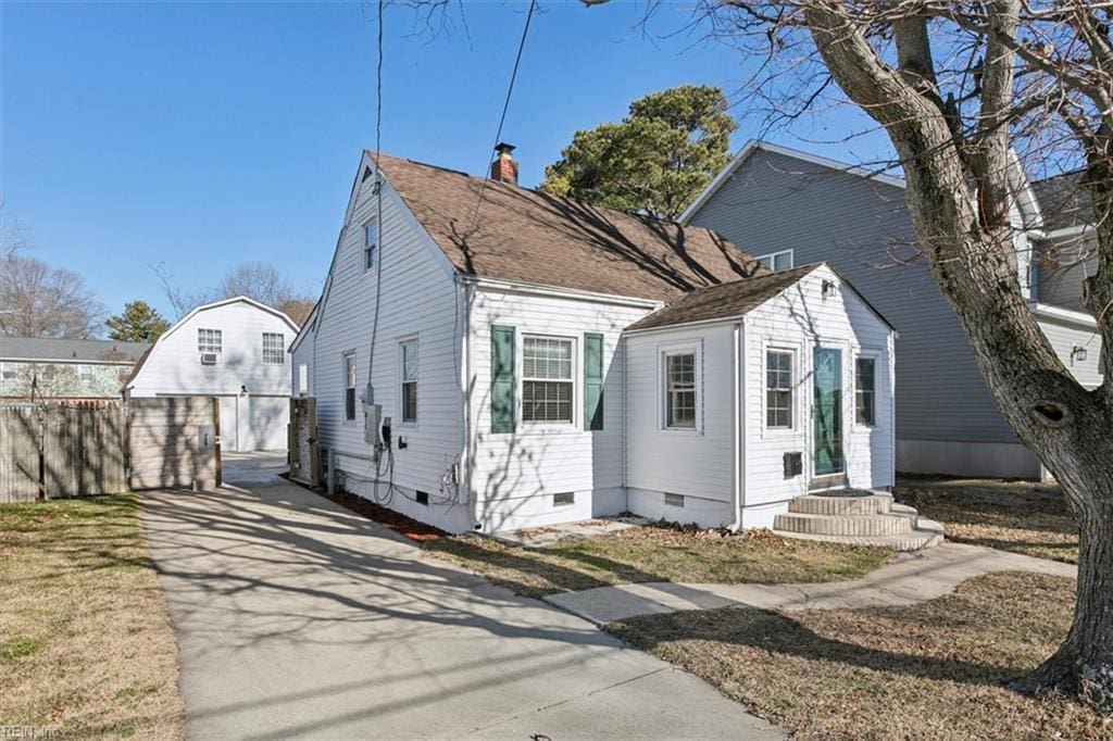 view of front of home featuring a garage and an outdoor structure