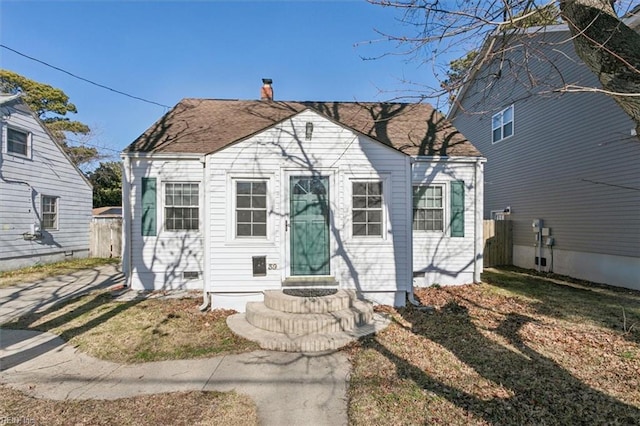 bungalow-style home featuring a front yard