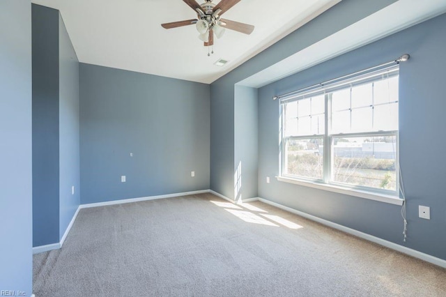 empty room featuring light colored carpet and ceiling fan