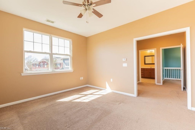 interior space with ceiling fan and light carpet