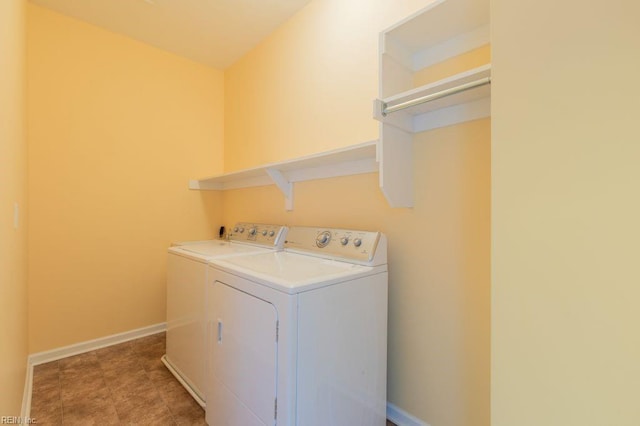 clothes washing area with washer and clothes dryer