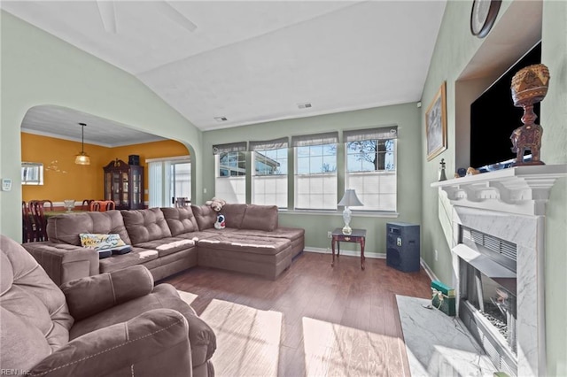 living room with light hardwood / wood-style flooring, lofted ceiling, and a fireplace