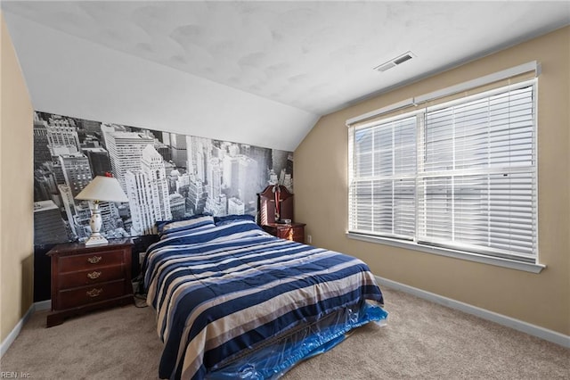 carpeted bedroom with lofted ceiling