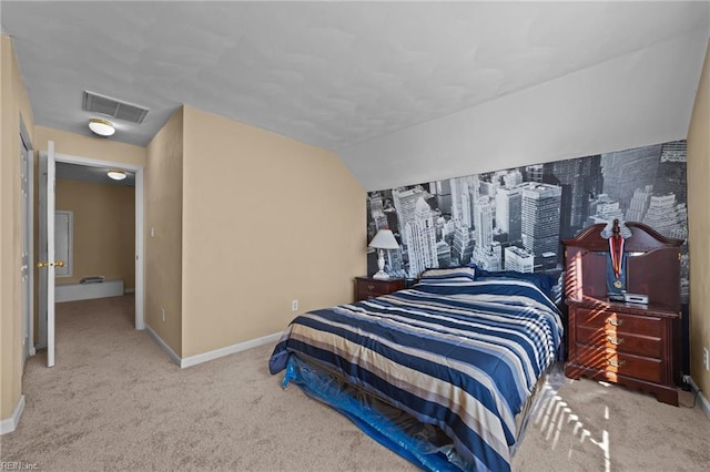 carpeted bedroom with vaulted ceiling