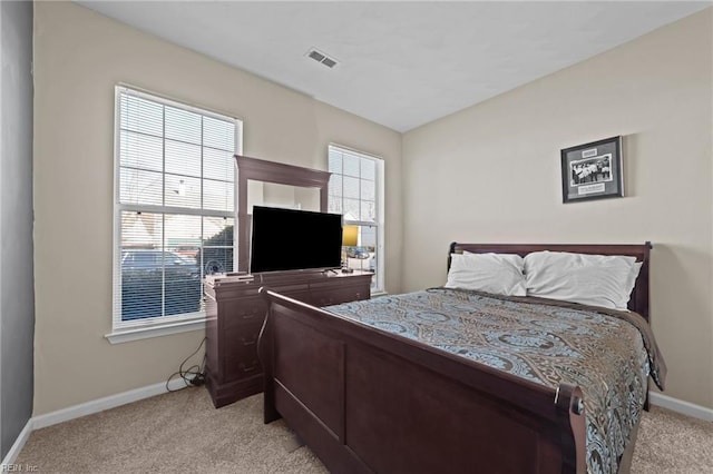 carpeted bedroom with multiple windows