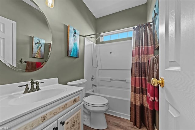 full bathroom with hardwood / wood-style floors, toilet, shower / bathtub combination with curtain, and vanity