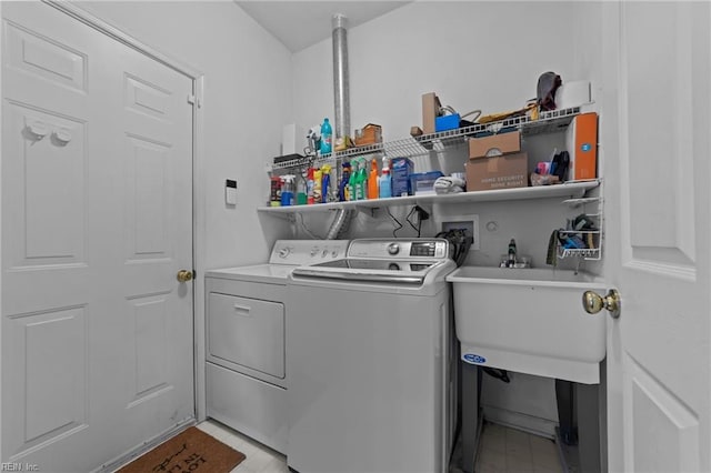 washroom featuring sink and washer and clothes dryer