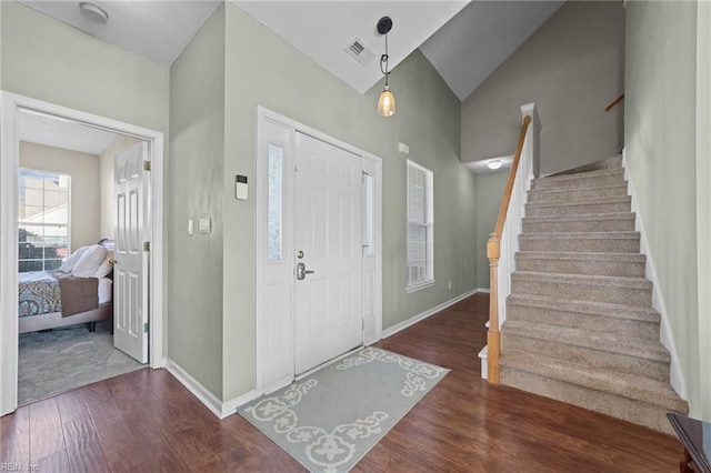 foyer featuring vaulted ceiling and dark hardwood / wood-style flooring