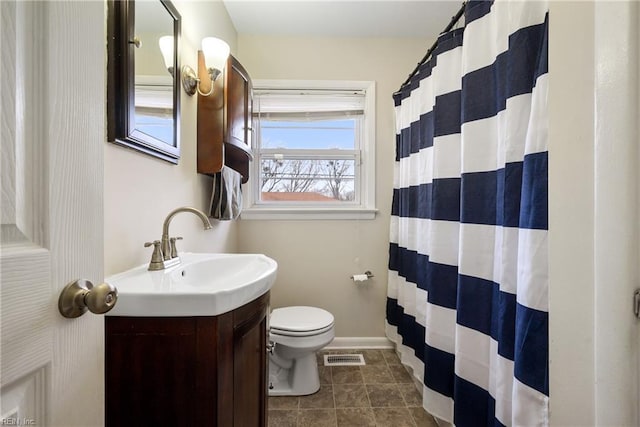 bathroom with toilet and vanity