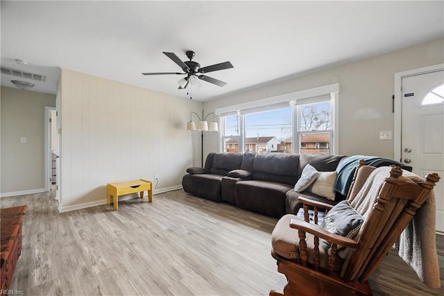 living room with light hardwood / wood-style floors and ceiling fan