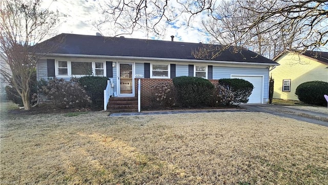 ranch-style house with a garage and a front yard