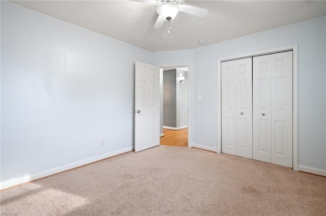 unfurnished bedroom featuring light carpet, ceiling fan, and a closet