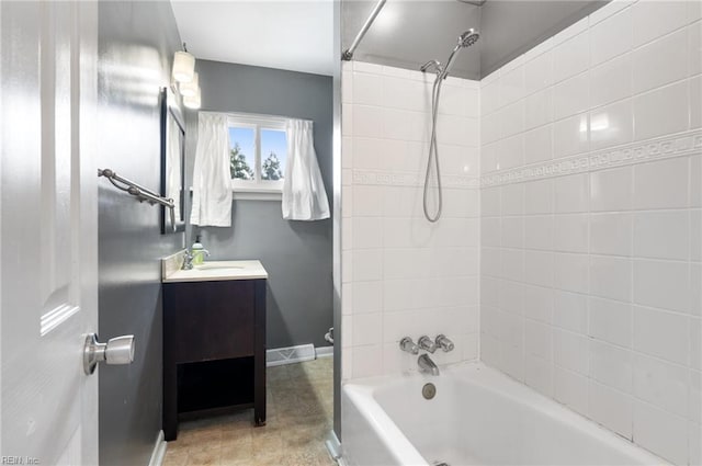 bathroom with vanity and tiled shower / bath