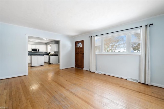 unfurnished living room with light wood-type flooring