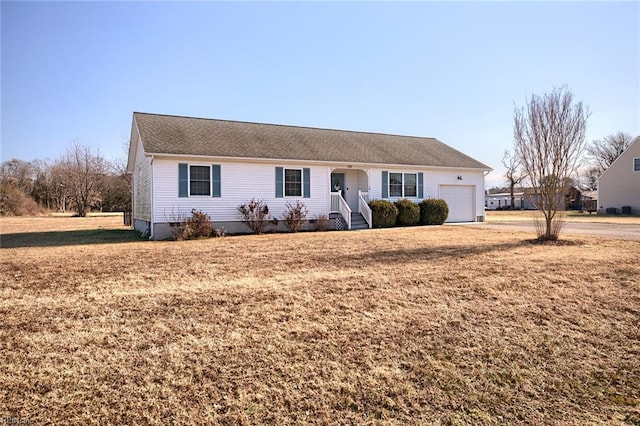 ranch-style house with a garage and a front yard