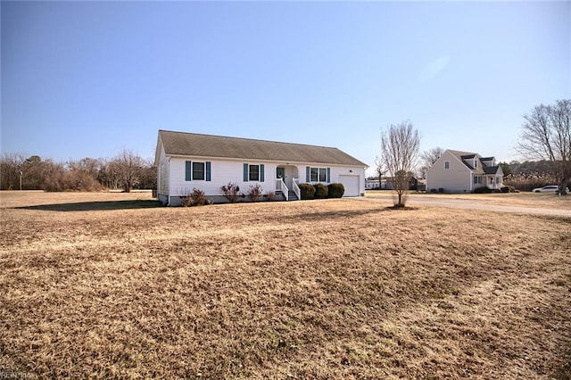 ranch-style home featuring a garage and a front yard