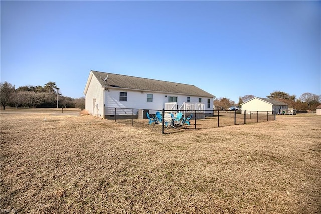 back of property with a lawn