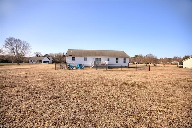 rear view of house featuring a lawn