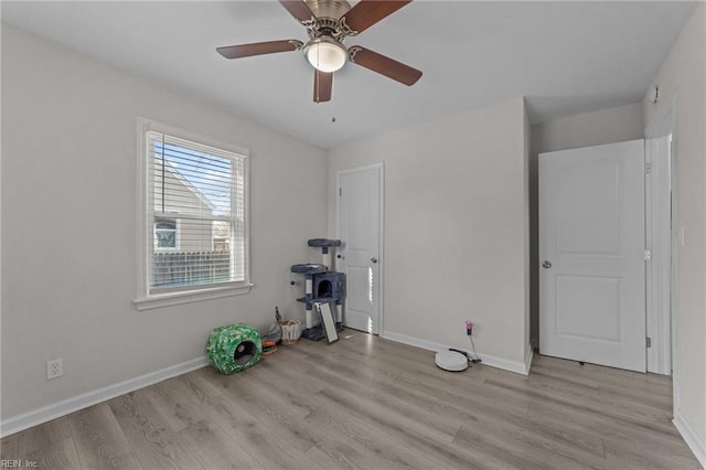 interior space with ceiling fan and light hardwood / wood-style flooring