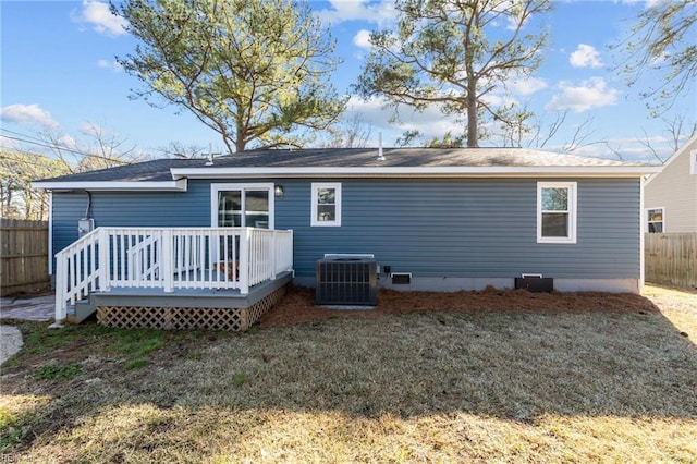 back of house with cooling unit, a yard, and a wooden deck