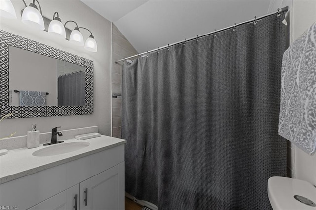 bathroom with vanity and vaulted ceiling