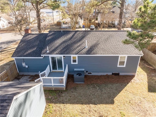 rear view of property featuring a wooden deck, a lawn, and central air condition unit