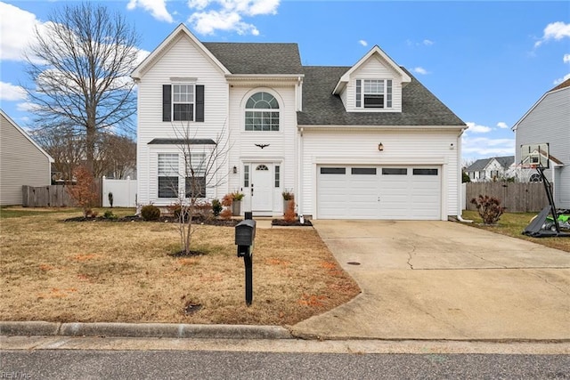 view of property with a garage and a front yard