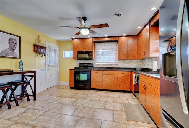 kitchen featuring tasteful backsplash, sink, black appliances, and ceiling fan