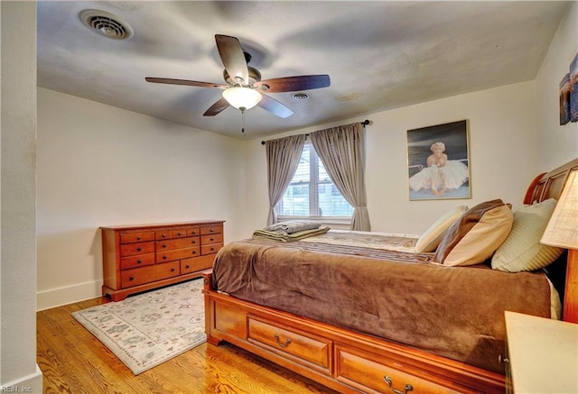 bedroom with ceiling fan and wood-type flooring