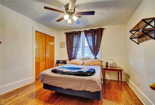 bedroom featuring hardwood / wood-style flooring, a closet, and ceiling fan