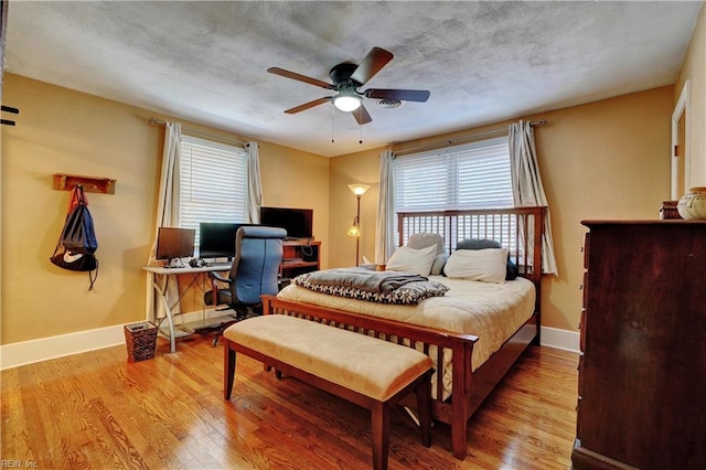 bedroom featuring hardwood / wood-style flooring and ceiling fan