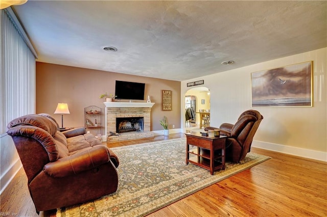 living room with hardwood / wood-style flooring and a fireplace