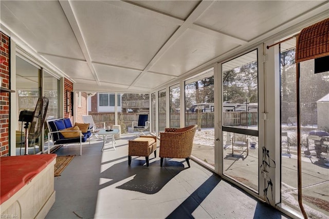 sunroom with coffered ceiling and a healthy amount of sunlight