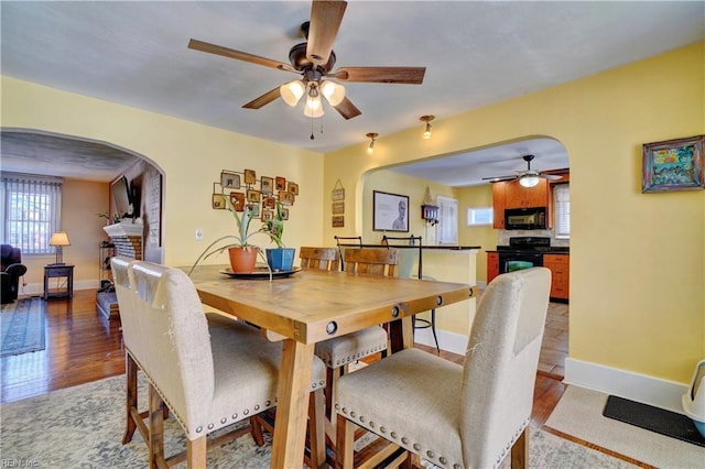 dining space featuring ceiling fan and light hardwood / wood-style flooring