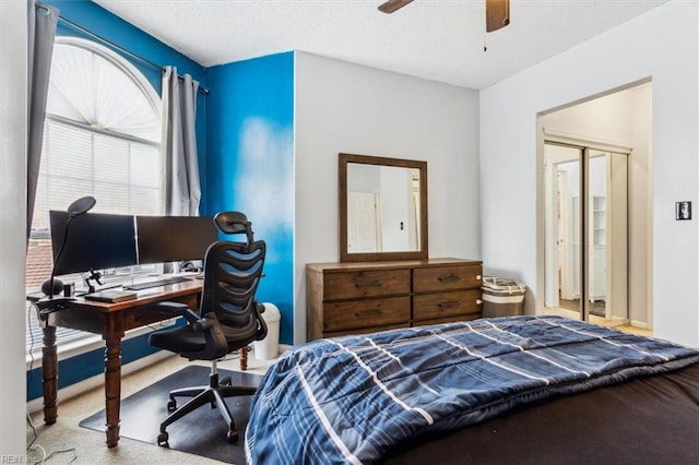 carpeted bedroom featuring a closet and ceiling fan